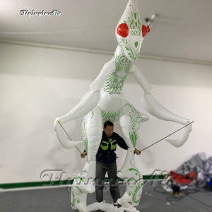 front of white walking inflatable mantis puppet