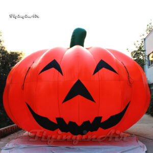 giant smiling inflatable pumpkin balloon on ground