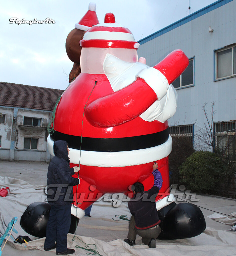 red hanging inflatable santa with bear