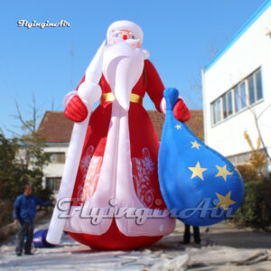 red inflatable santa with a gift box on the left hand