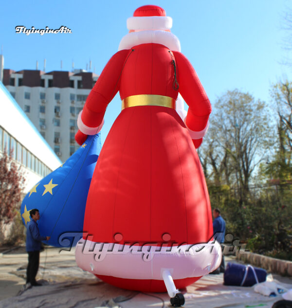 back of red inflatable santa with a gift bag