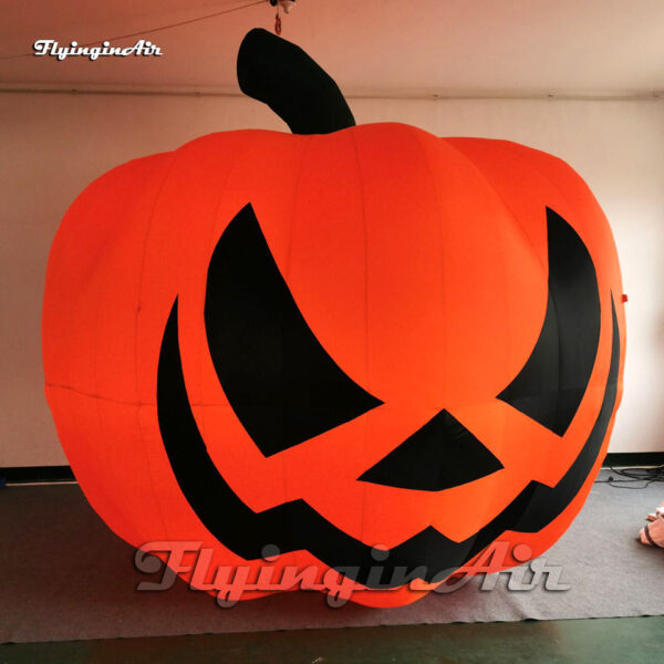 large inflatable pumpkin head balloon on ground
