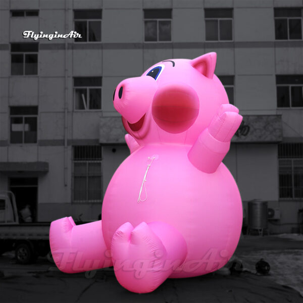 pink inflatable pig balloon sitting on the ground