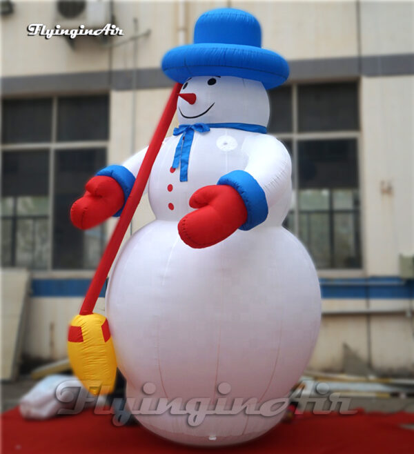 white inflatable snowman with broom