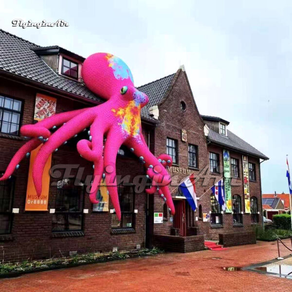 large-pink-inflatable-octopus-on-building-wall