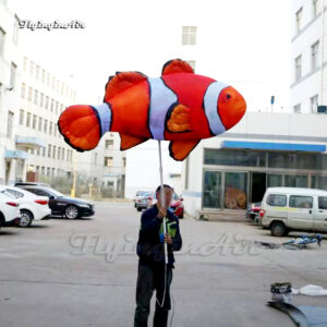 holding giant inflatable clownfish puppet