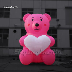 pink giant inflatable teddy bear with a heart balloon