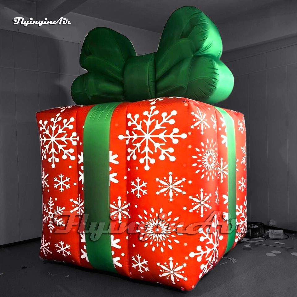 Side view of a custom inflatable Christmas present model showing detailed snowflake printing, available for wholesale.