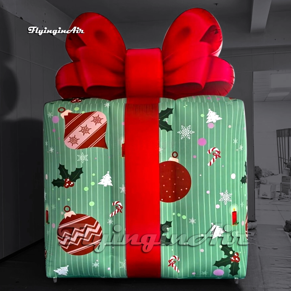 Front view of a 4m giant inflatable Christmas gift box with a red bow and festive green wrapping paper, ideal for mall decorations.