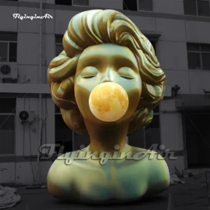 Front view of a 6m giant inflatable pop art woman bust with golden hair blowing a bubble, ideal for art exhibitions and mall decorations.