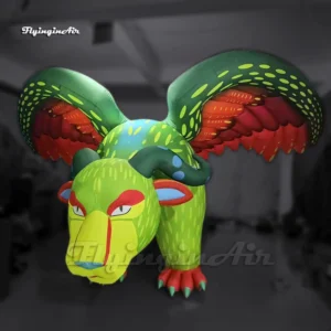Front view of a 5m long giant inflatable Alebrije Pepita with red and green wings, ideal for Coco themed theme parks and the day of the dead parties.